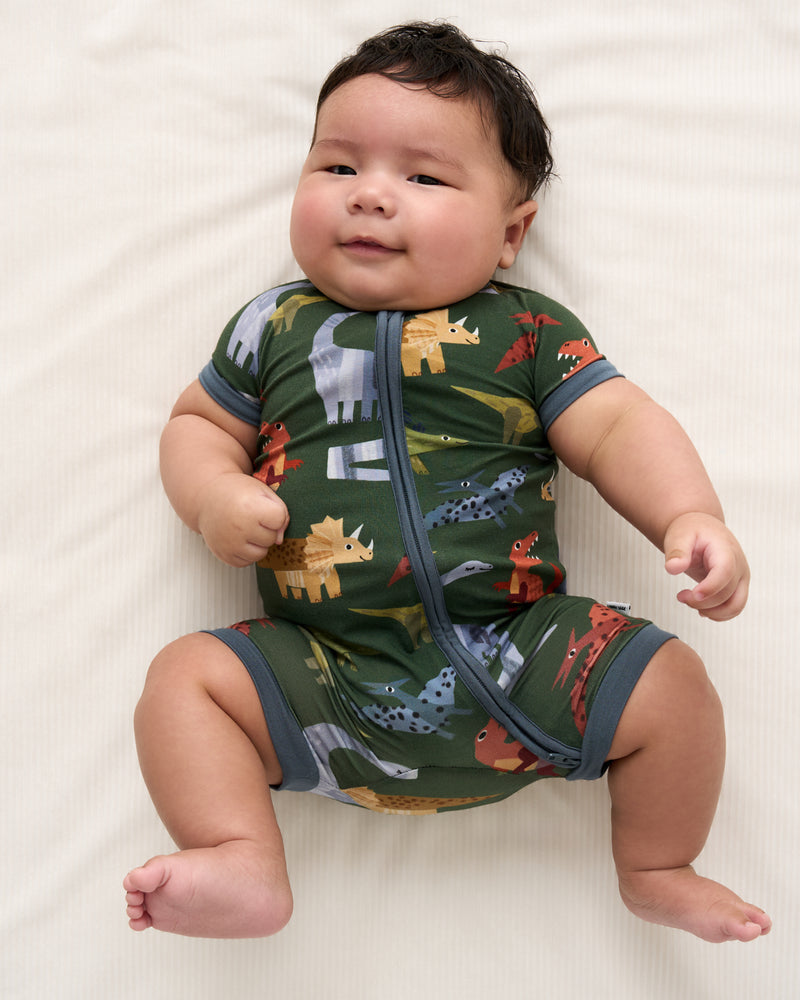 Close up overhead view of baby wearing the Green Roar & Explore Shorty Zippy