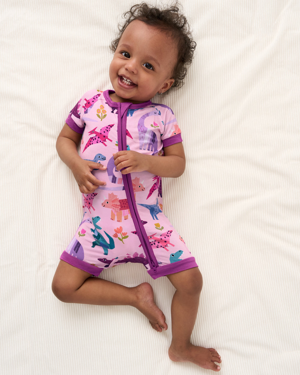 Overhead view of baby wearing the Pink Roar & Explore Shorty Zippy