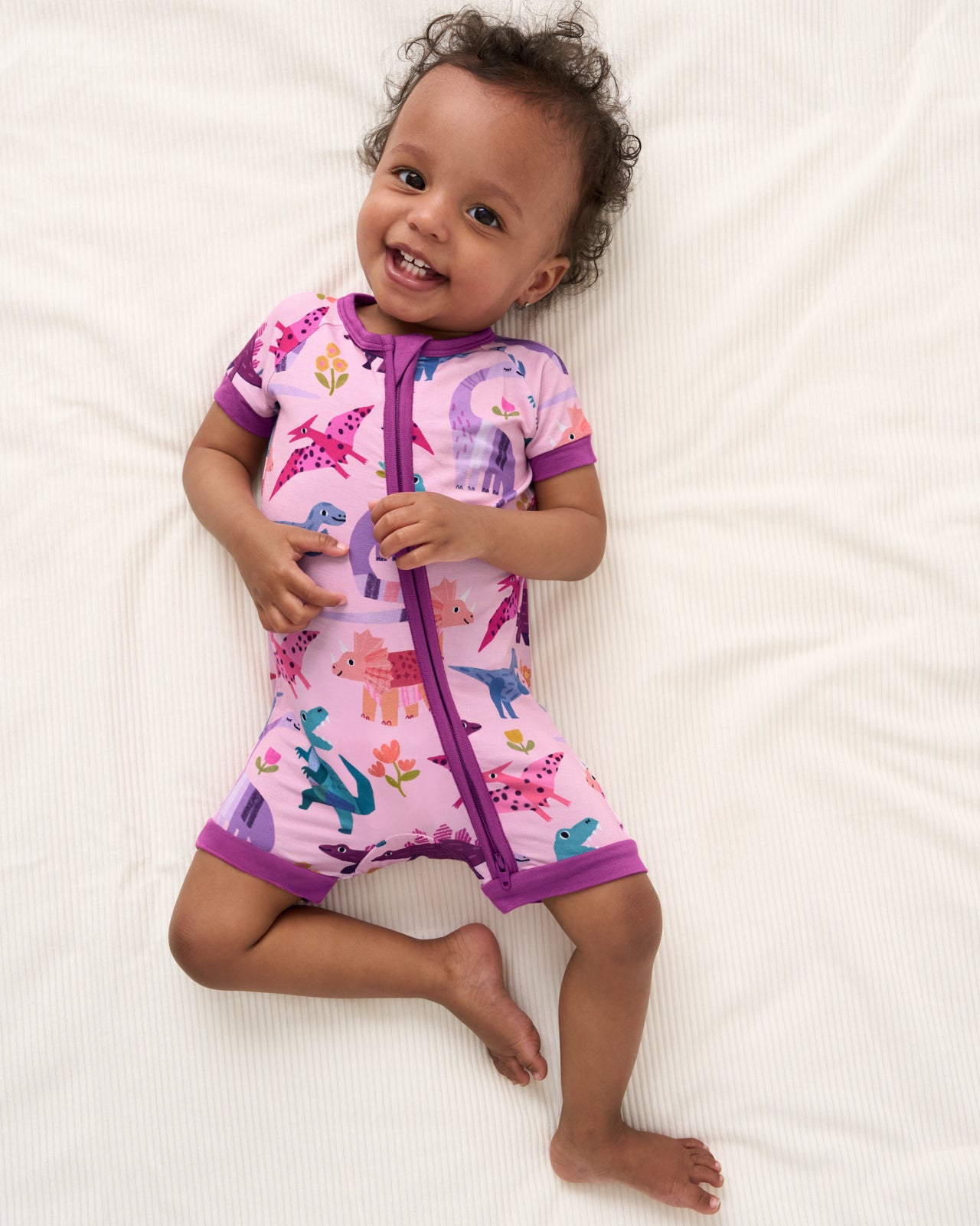 Overhead view of baby wearing the Pink Roar & Explore Shorty Zippy