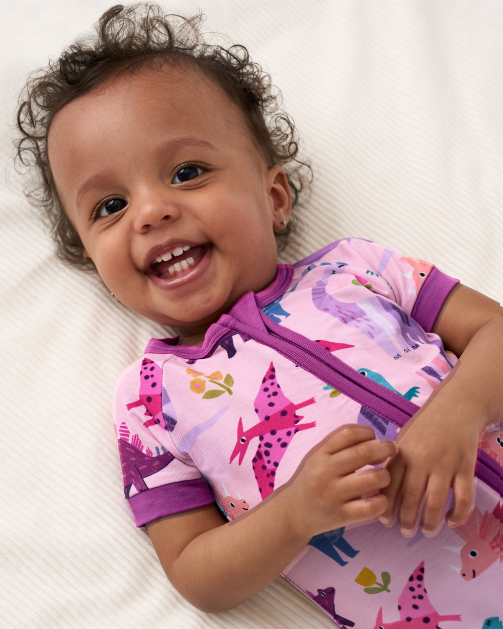 Close up of baby wearing the Pink Roar & Explore Shorty Zippy