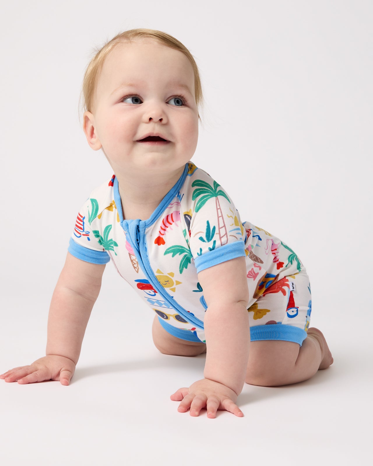 Crawling baby wearing the Ciao Bella Shorty Zippy