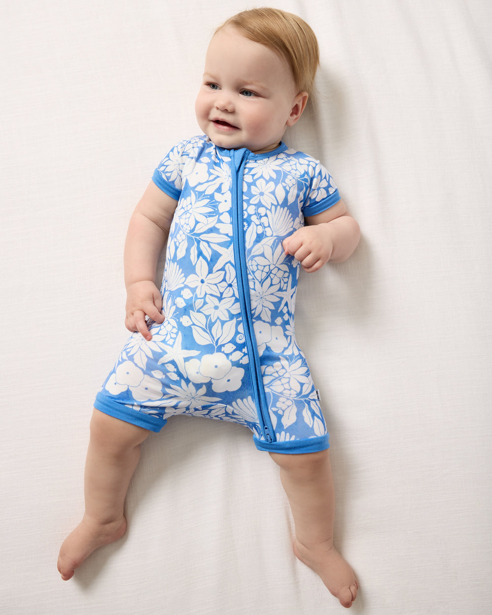 Aerial view of baby wearing the Azure Garden Shorty Zippy
