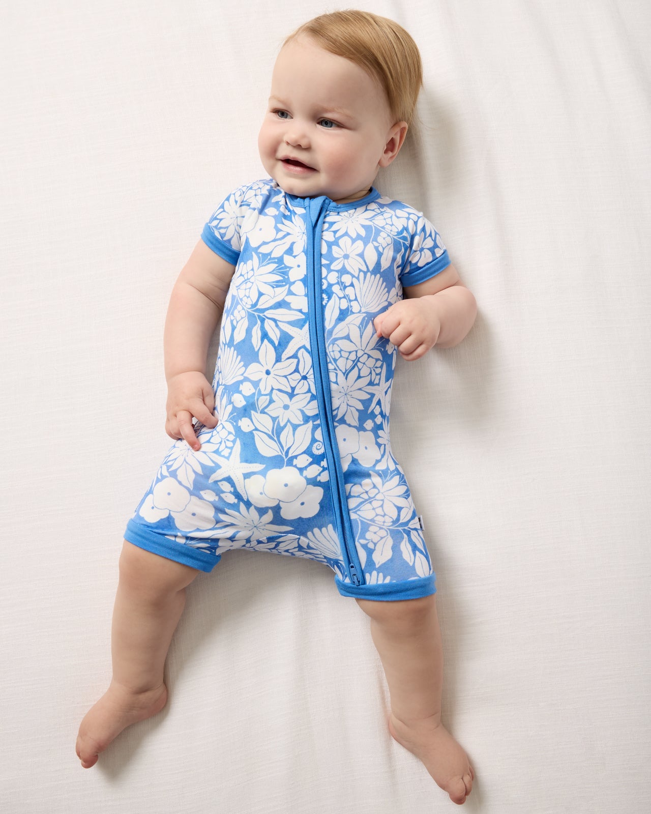 Aerial view of baby wearing the Azure Garden Shorty Zippy