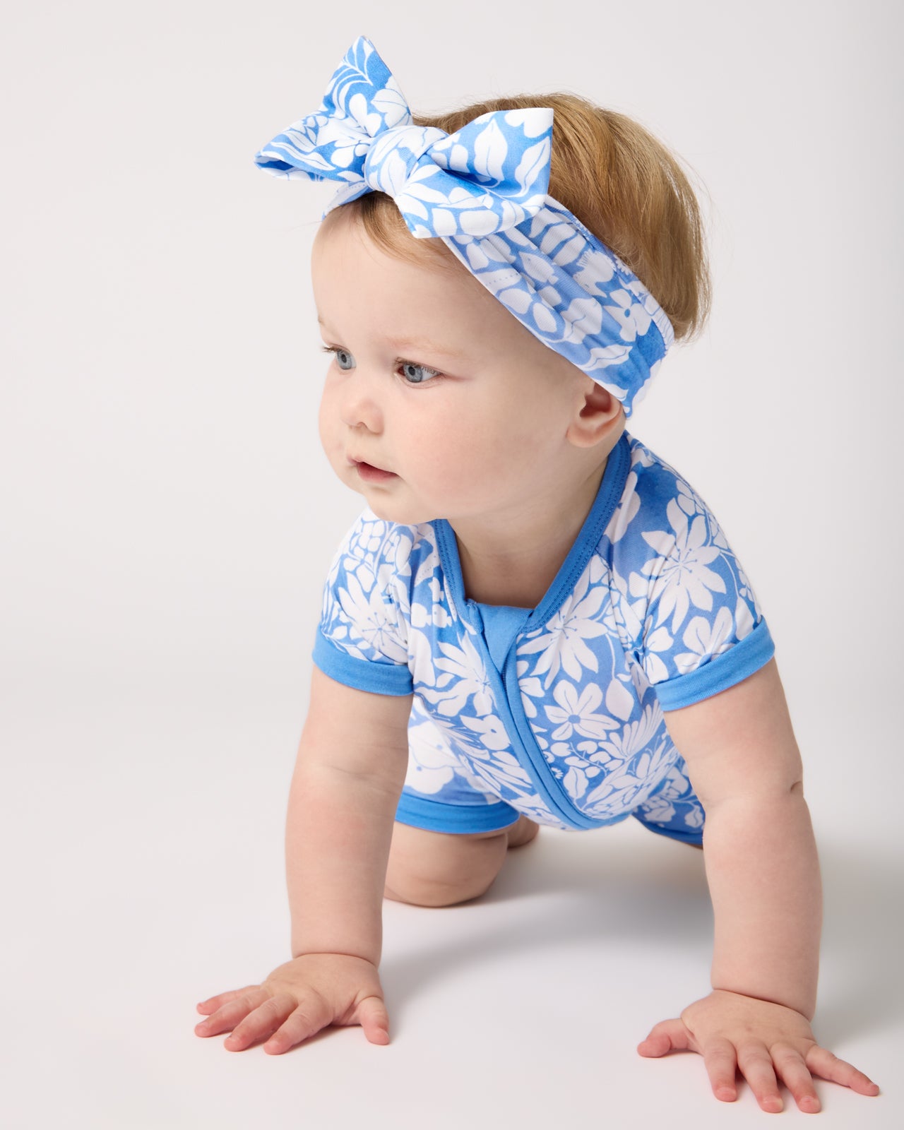 Baby wearing the Azure Garden Luxe Bow Headband and Shorty Zippy