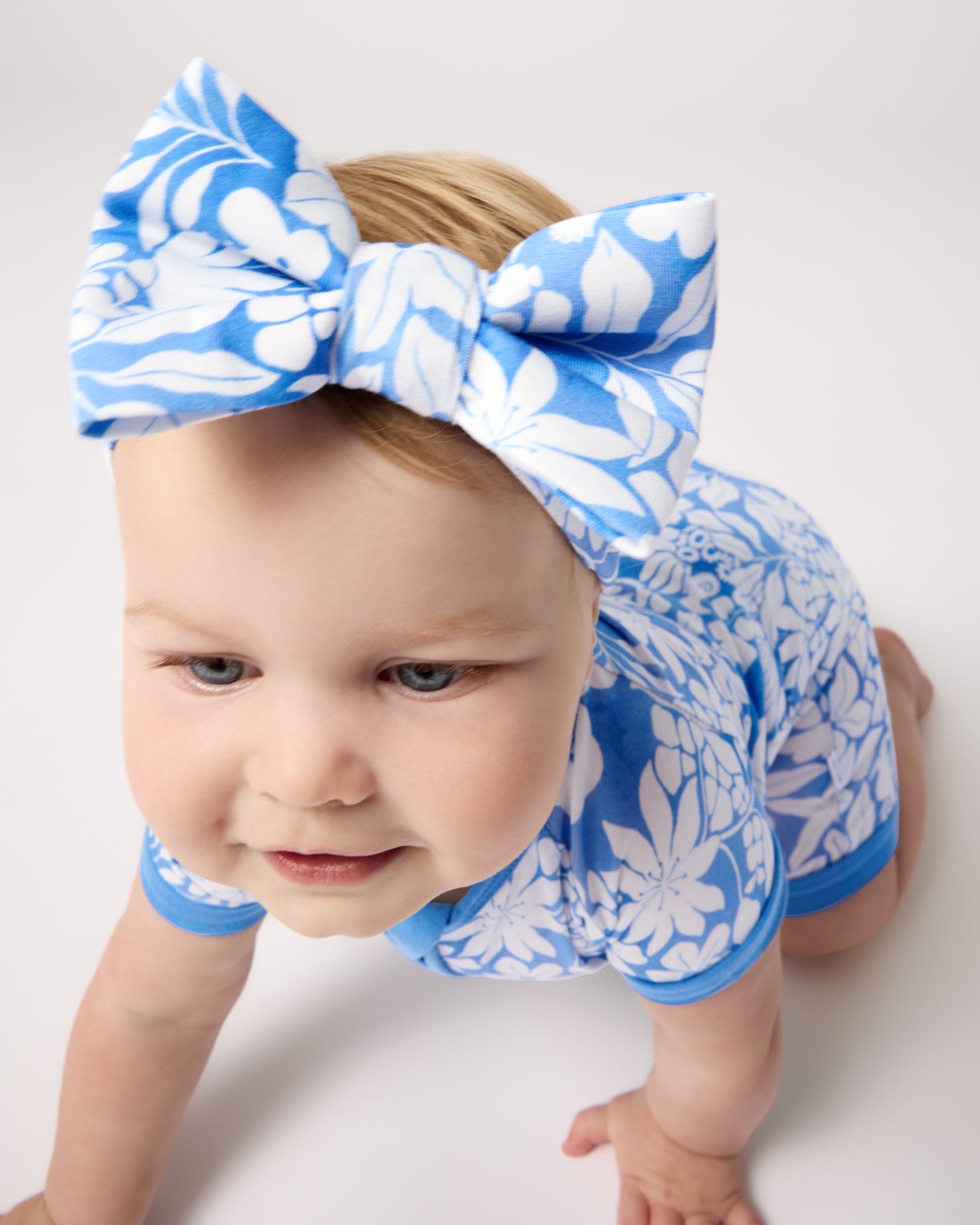 Crawling baby wearing the Azure Garden Luxe Bow Headband