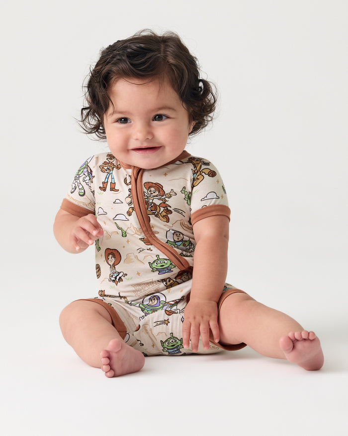 Sitting baby wearing the Disney & Pixar Woody's Wild West Shorty Zippy