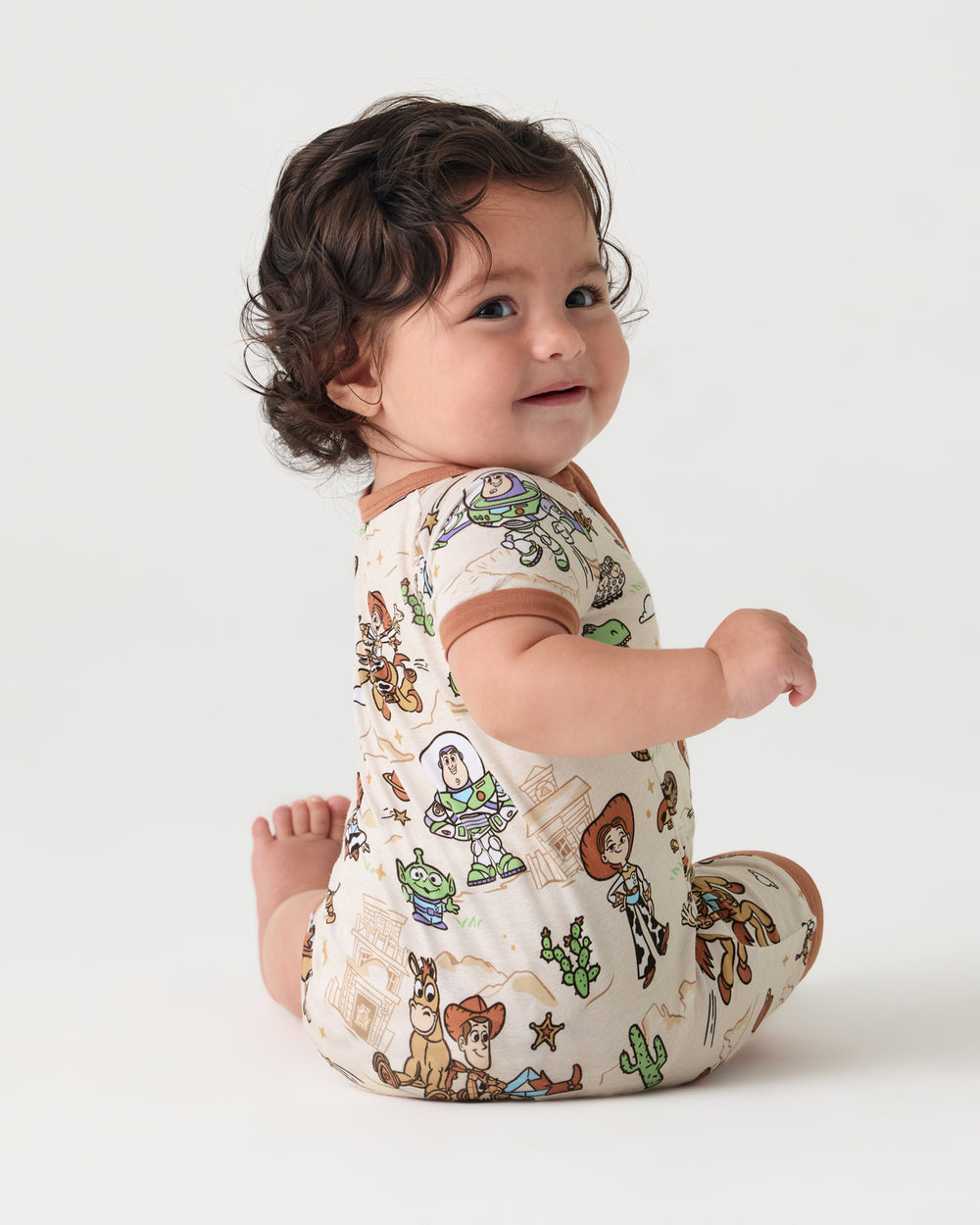 Back view of baby wearing the Disney & Pixar Woody's Wild West Shorty Zippy