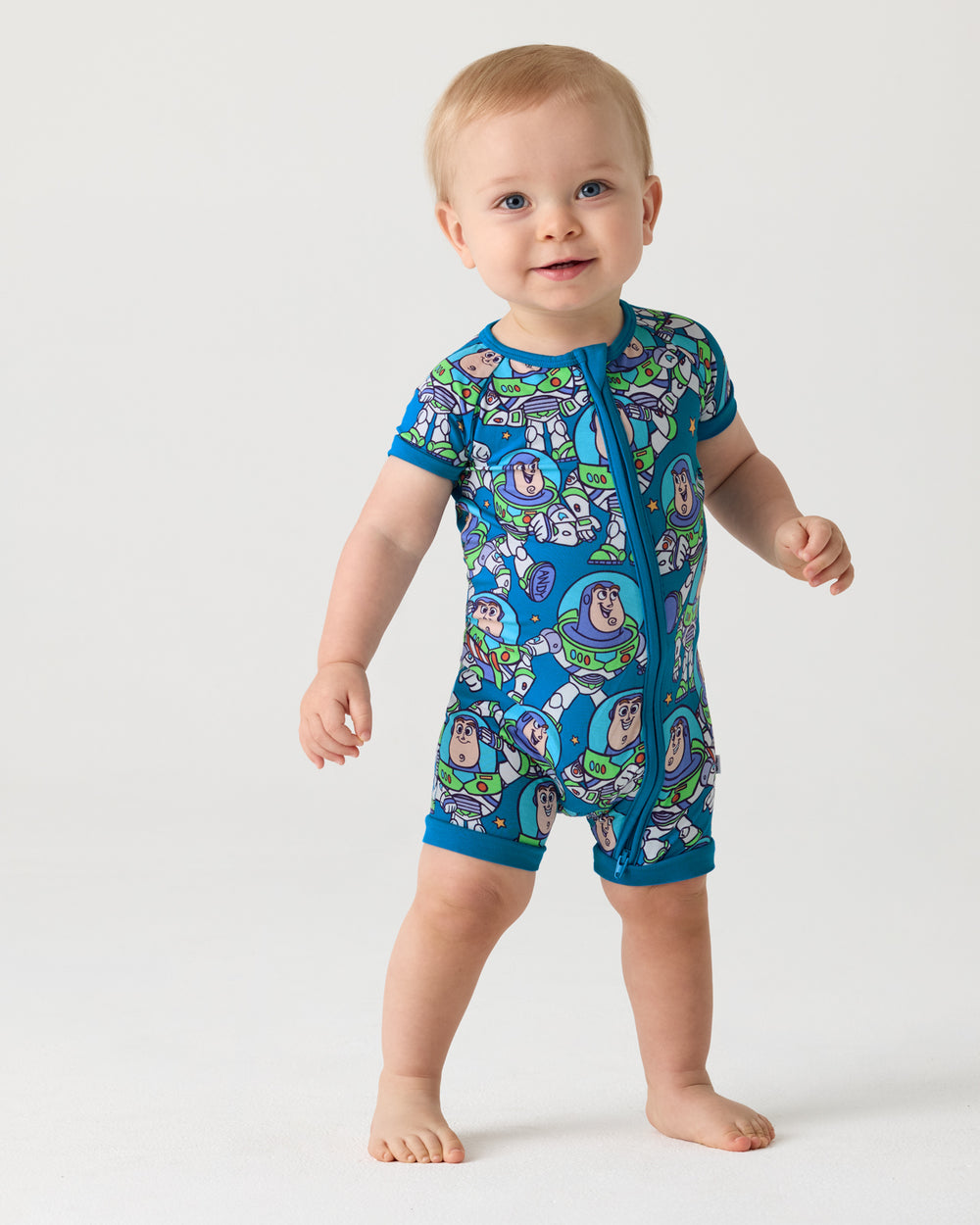 Standing baby wearing the Disney & Pixar Buzz's Cosmic Crew Shorty Zippy