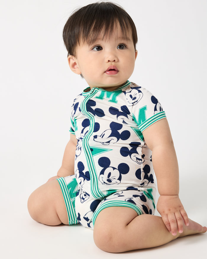 Sitting baby wearing the Disney Varsity Mickey Mouse Shorty Zippy