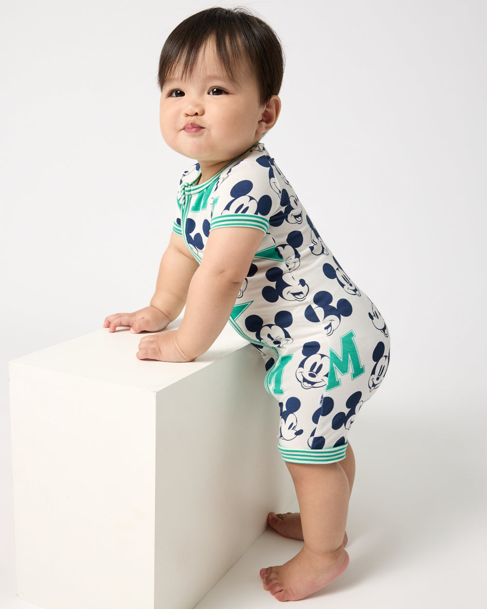Standing baby wearing the Disney Varsity Mickey Mouse Shorty Zippy Pajama