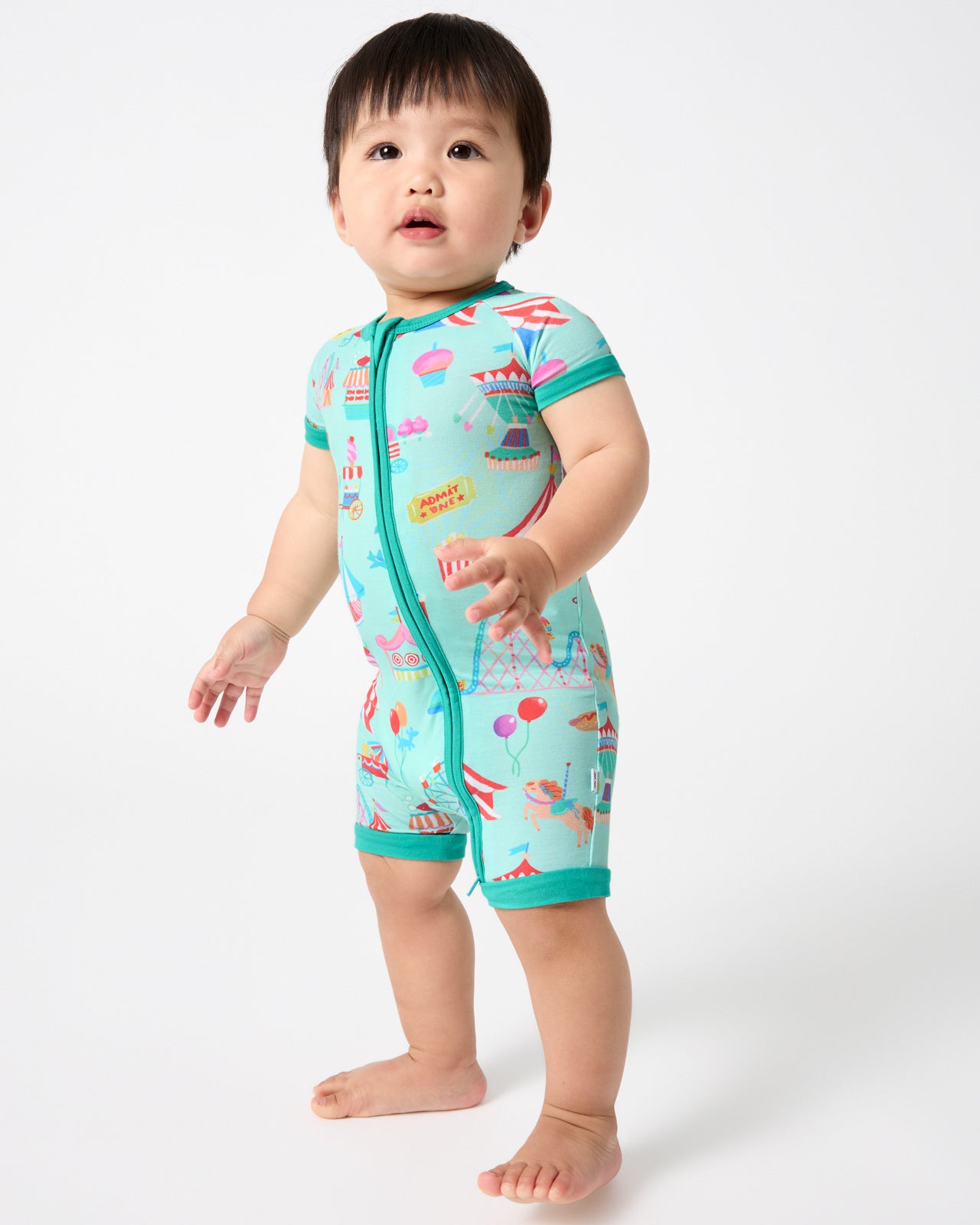 Standing baby wearing the Fizzy Fair Shorty Zippy