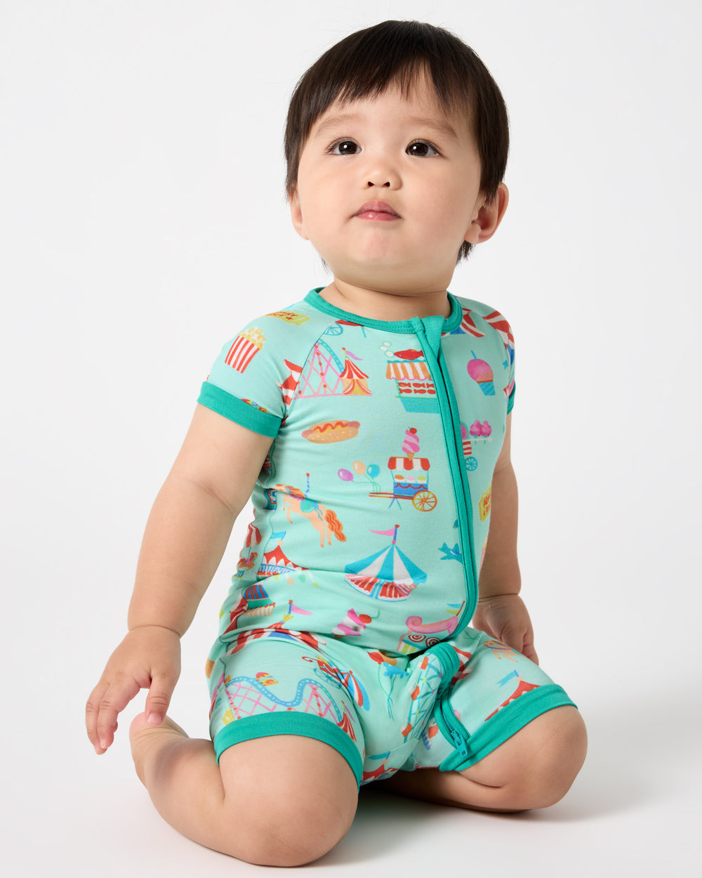 Sitting baby wearing the Fizzy Fair Shorty Zippy
