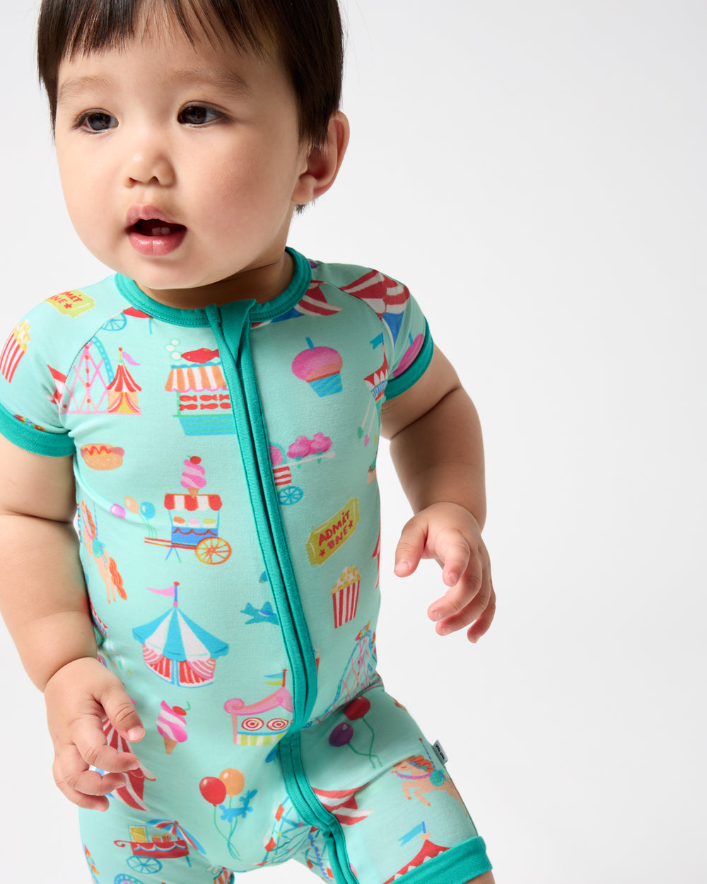 Close up of baby wearing the Fizzy Fair Shorty Zippy