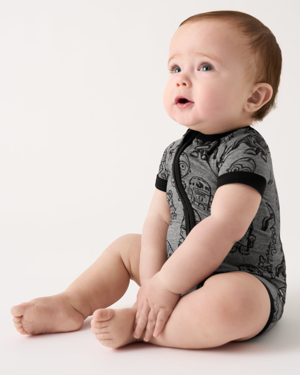 Sitting baby wearing the Star Wars Far, Far, Away Friends Shorty Zippy