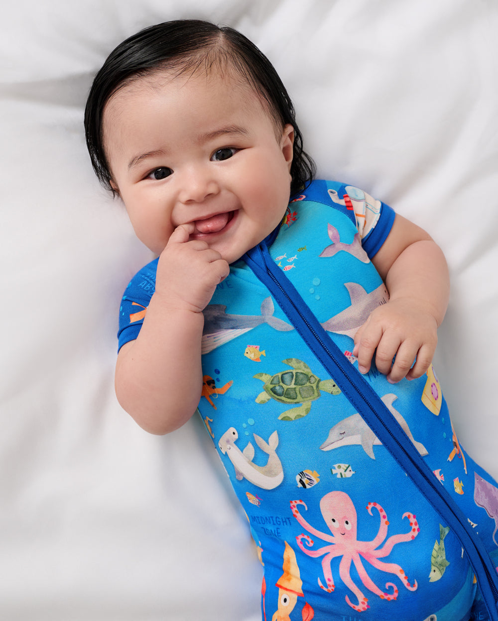 Close up of baby wearing the Underwater Discovery Shorty Zippy