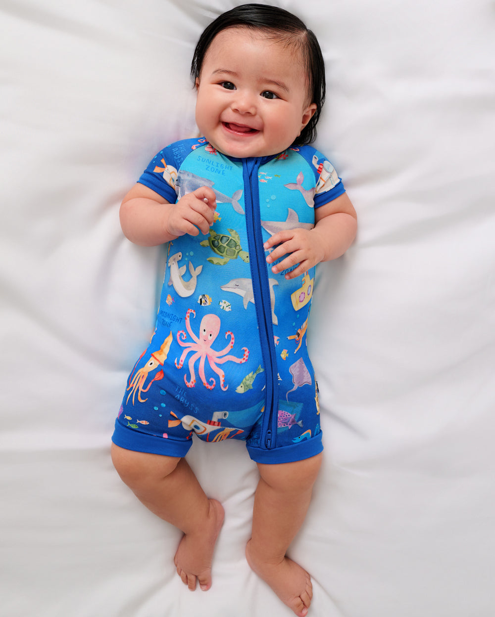 Aerial view of baby wearing the Underwater Discovery Shorty Zippy
