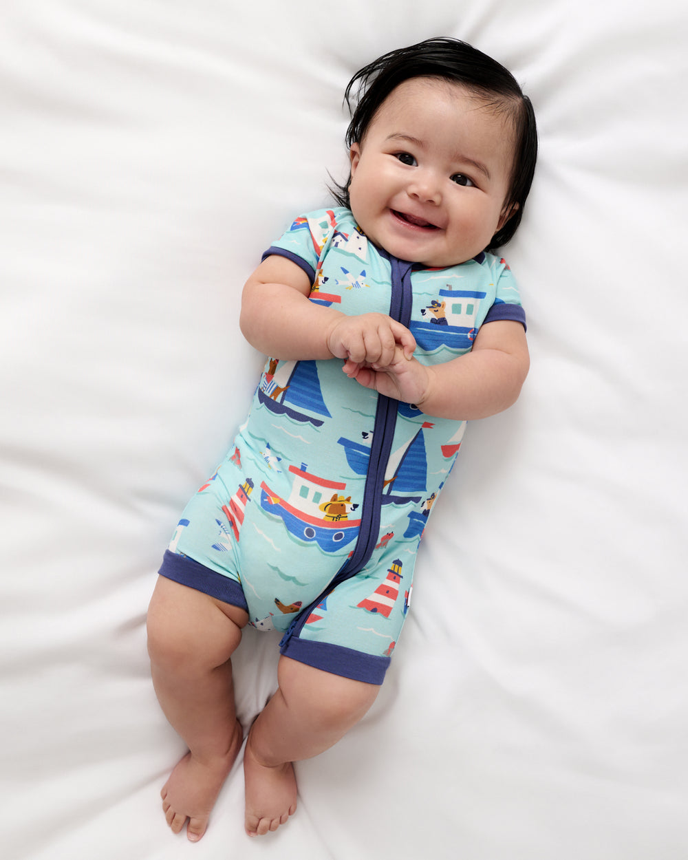 Aerial view of baby wearing the Nautical Paws Shorty Zippy