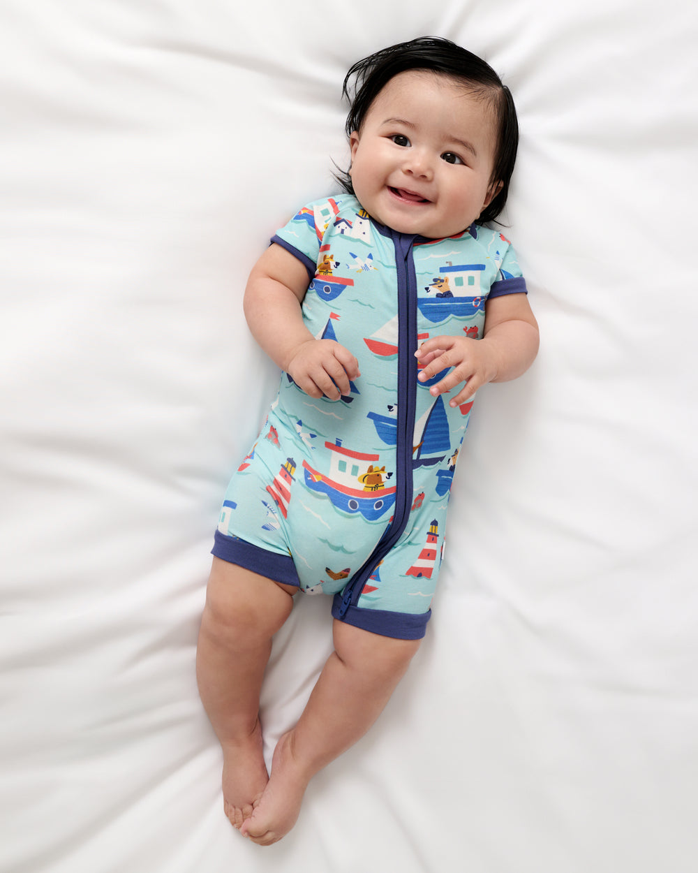 Alternate aerial view of baby wearing the Nautical Paws Shorty Zippy