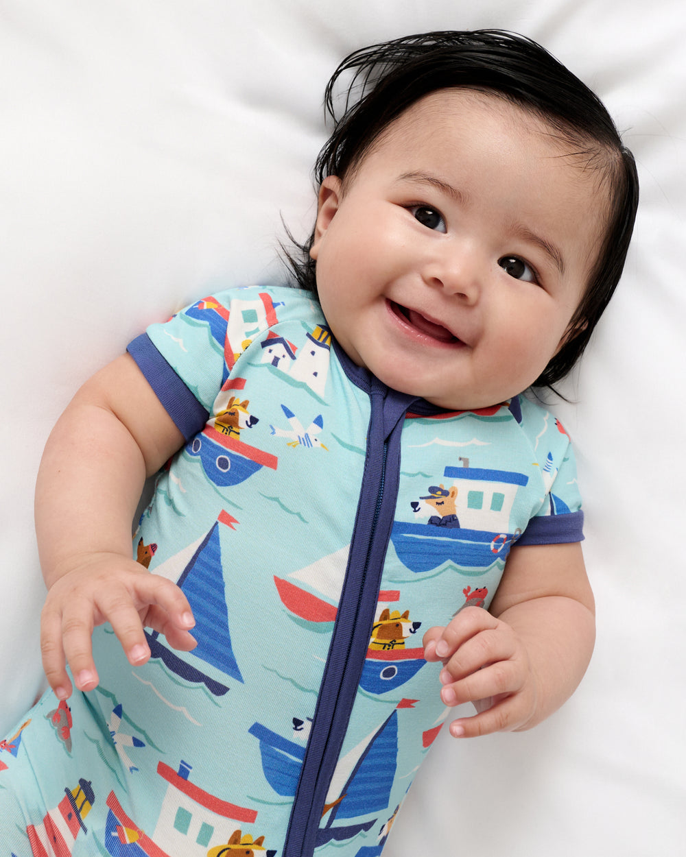 Close up of baby wearing the Nautical Paws Shorty Zippy