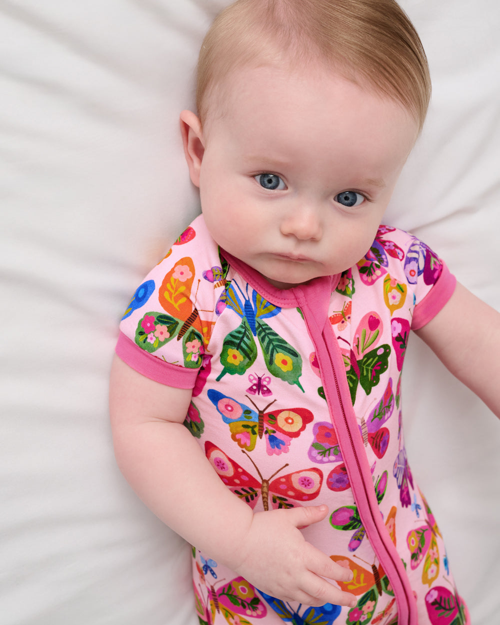 Close up of baby wearing the Flutter Garden Shorty Zippy