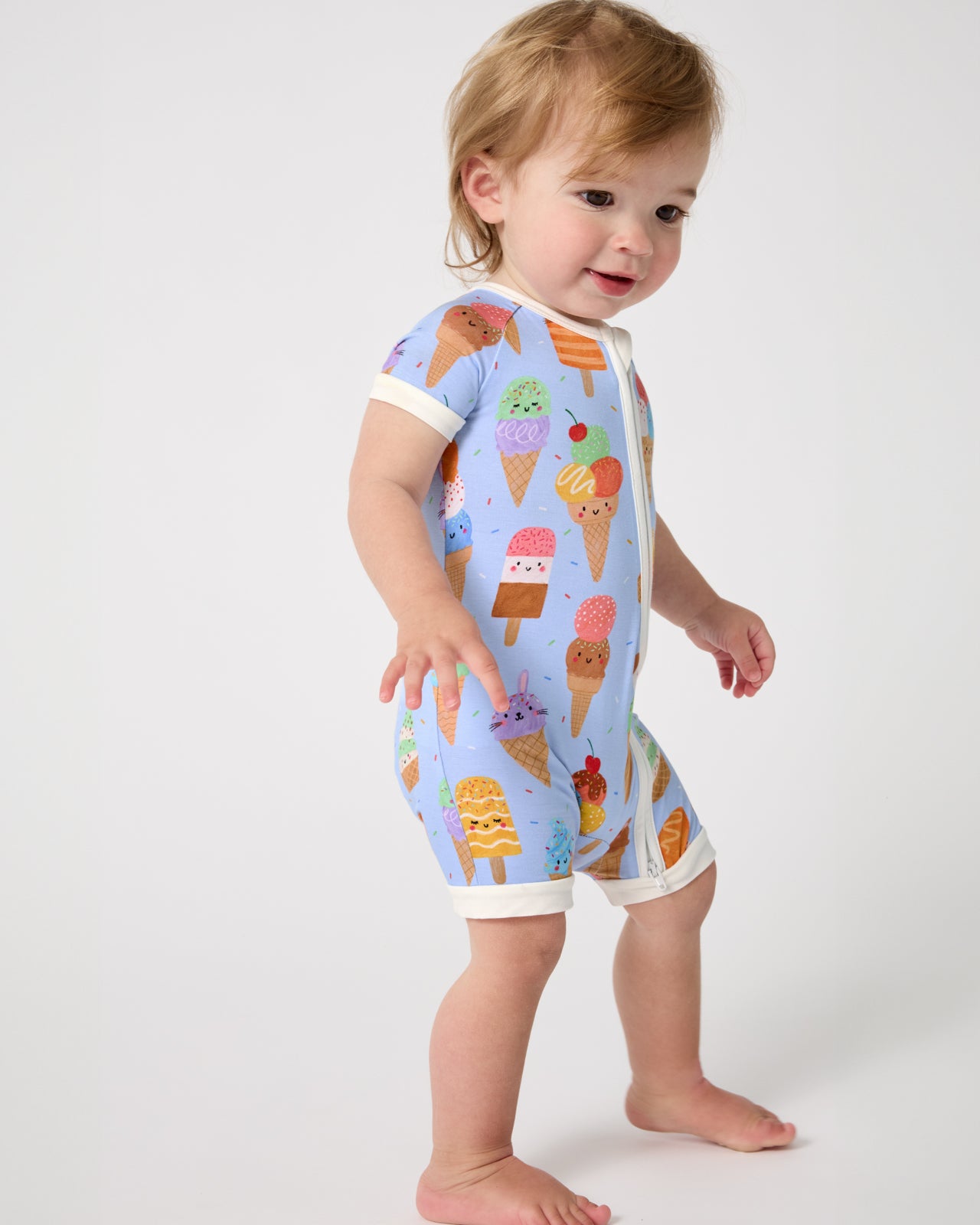 Standing baby wearing the Scoop Squad Shorty Zippy