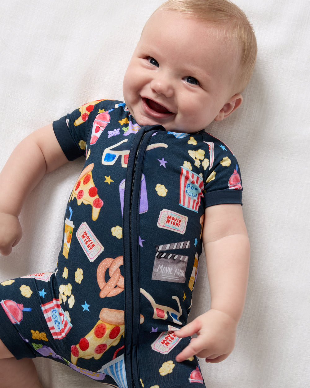 Close up of baby wearing the Movie Marathon Shorty Zippy