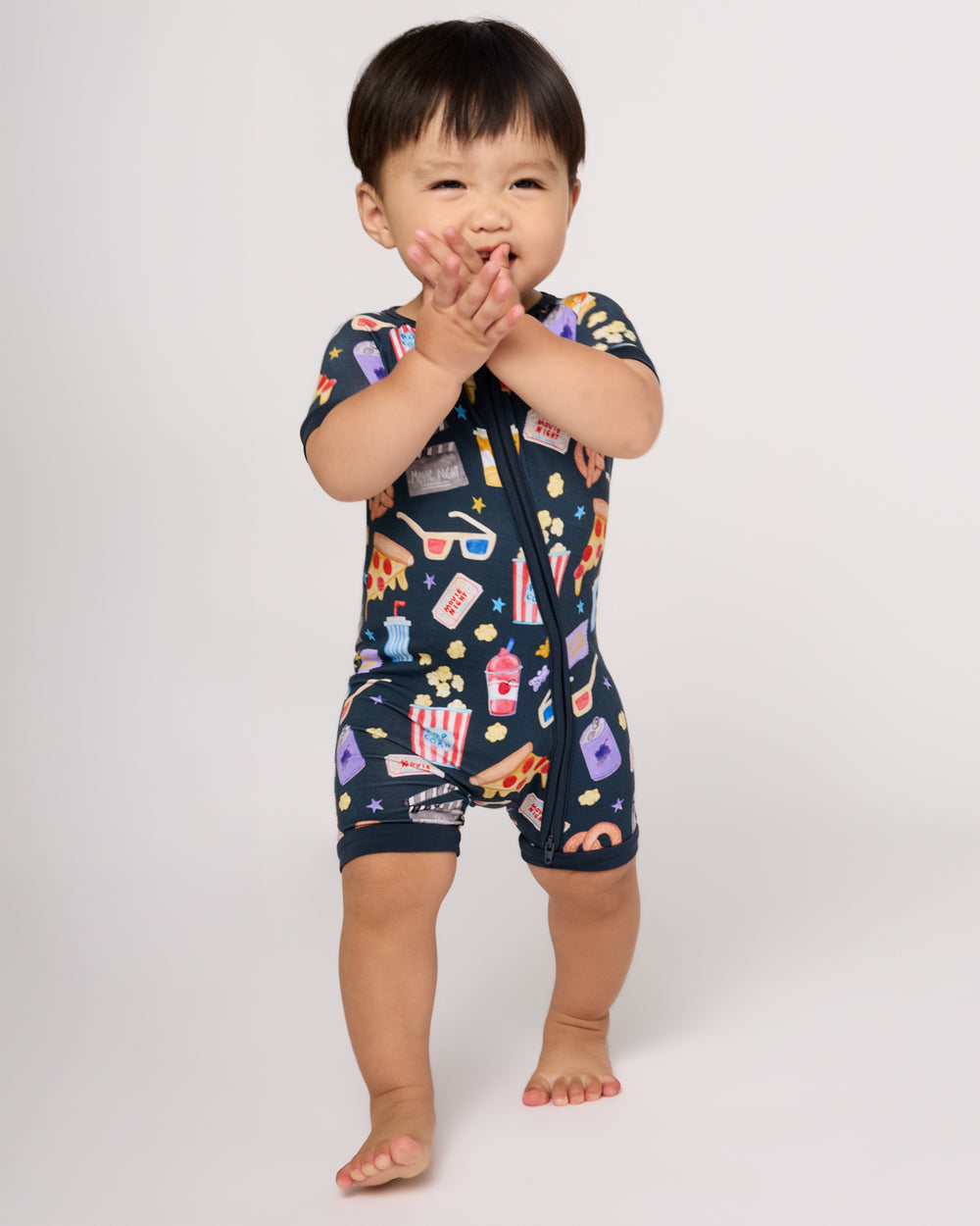 Walking toddler wearing the Movie Marathon Shorty Zippy
