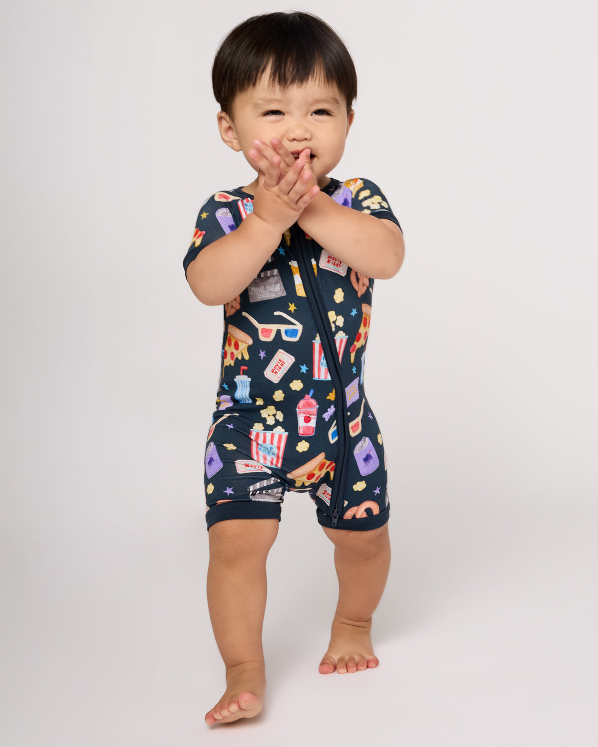 Walking toddler wearing the Movie Marathon Shorty Zippy