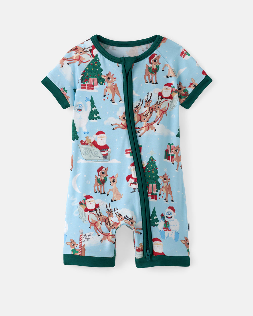 A baby short-sleeve romper in light blue with a festive Christmas print featuring Santa Claus, reindeer, snowmen, and Christmas trees, finished with dark green trim and a front zipper.