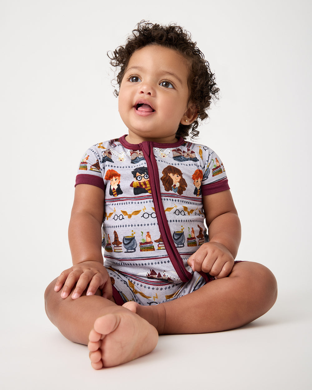 Sitting baby wearing the Harry Potter™ Spellbinding Studies Shorty Zippy