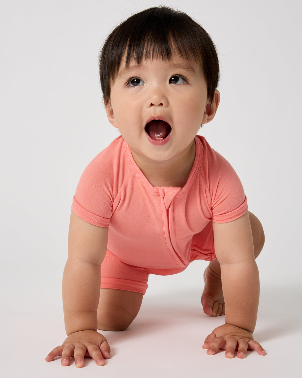 Crawling baby wearing the Sweet Papaya Shorty Zippy