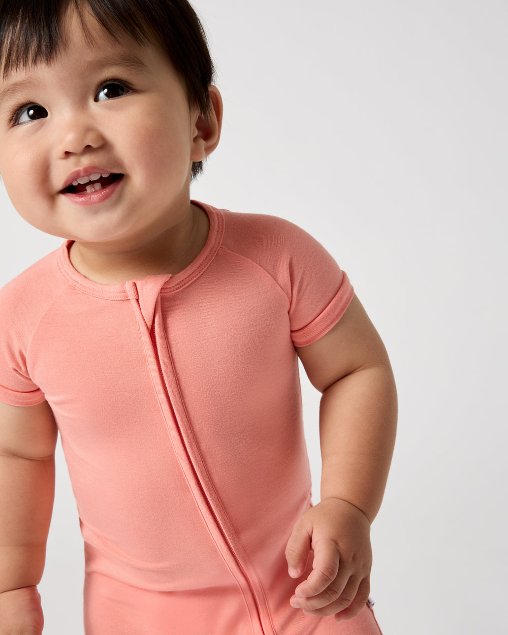 Close up of baby wearing the Sweet Papaya Shorty Zippy