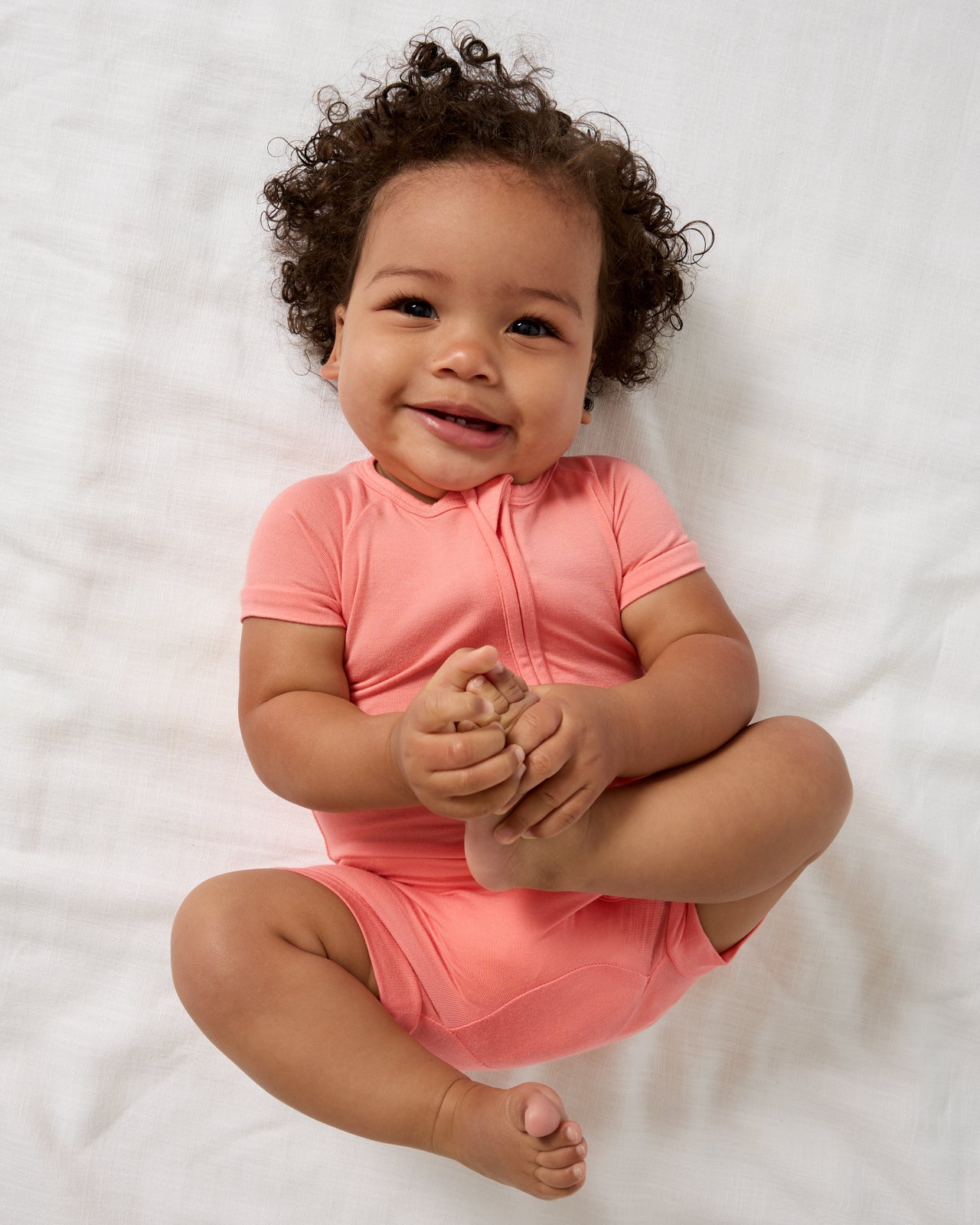 Aerial view of baby wearing the Sweet Papaya Shorty Zippy