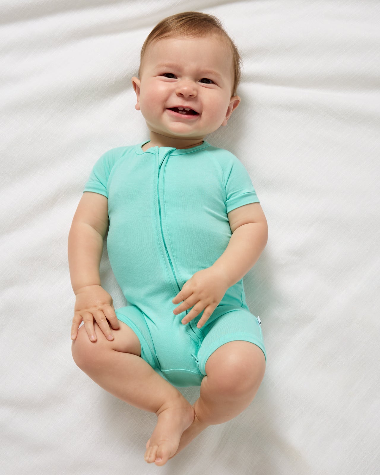 Aerial view of baby wearing the Ocean Mist Shorty Zippy