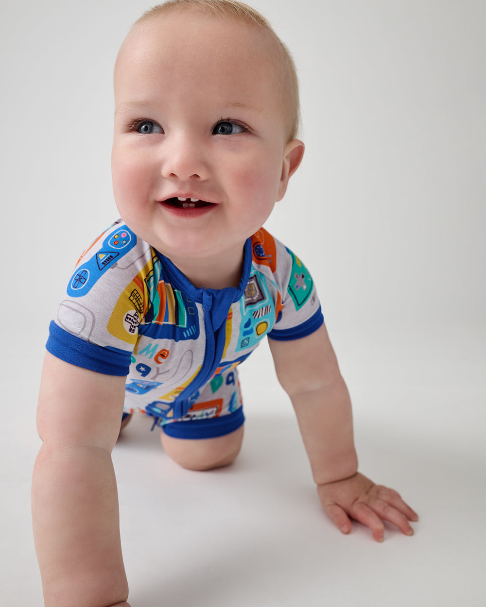 Crawling baby wearing the Game On Shorty Zippy