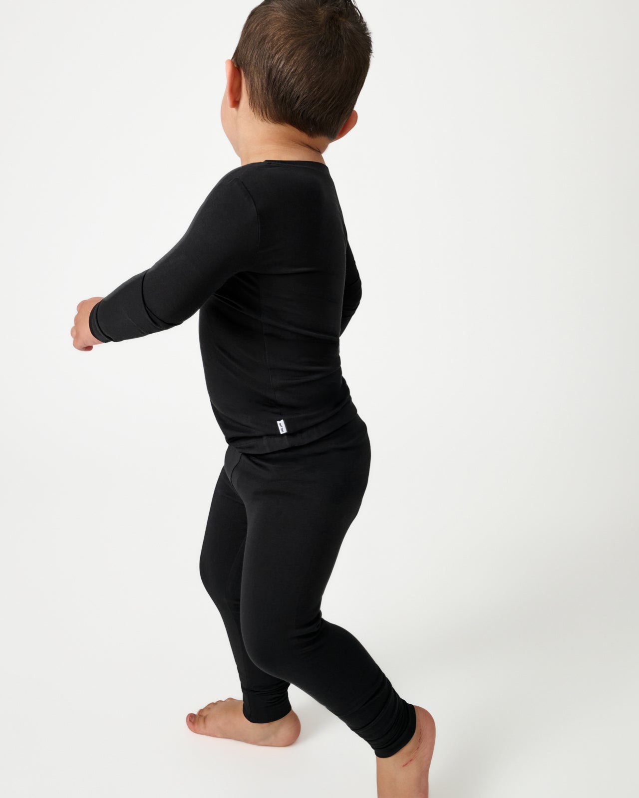 Walking child wearing the Black Two-Piece Pajama Set