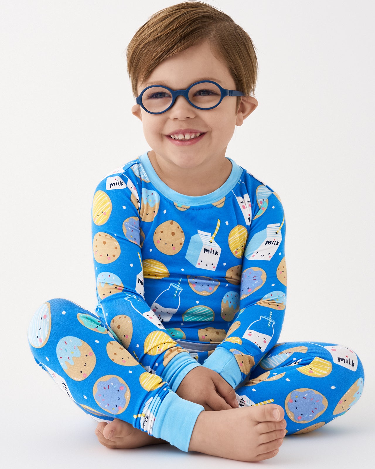 Sitting child wearing the Blue Cookies & Milk Two-Piece Pajama Set