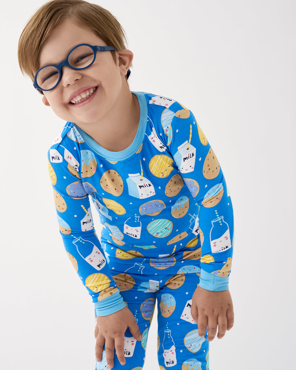 Close up of boy wearing the Blue Cookies & Milk Two-Piece Pajama Set