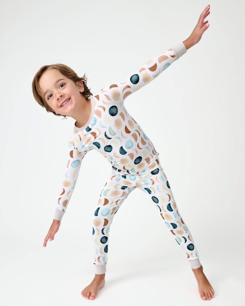 Posing boy wearing the Luna Neutral Two-Piece Pajama Set