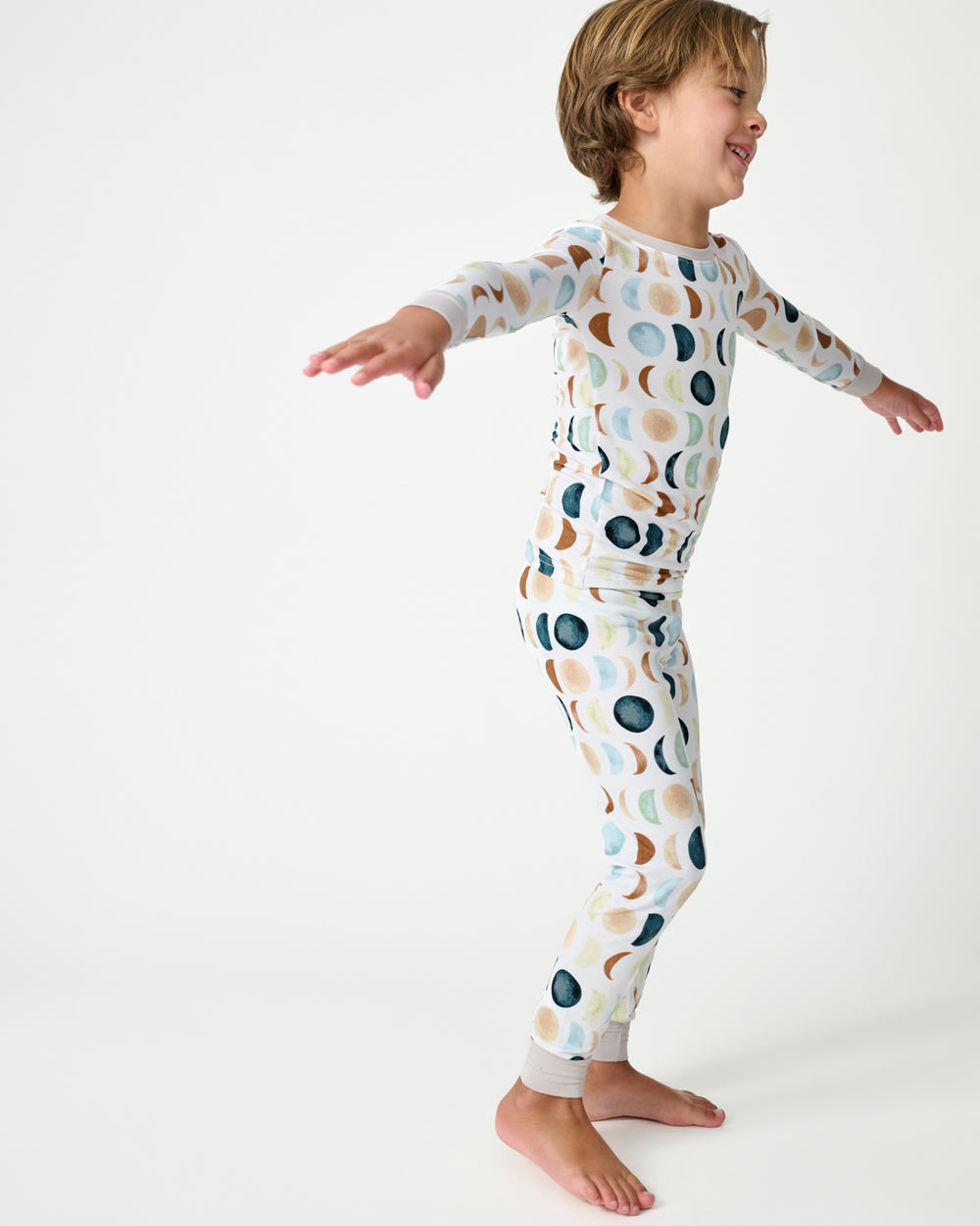 Standing child wearing the Luna Neutral Two-Piece Pajama Set