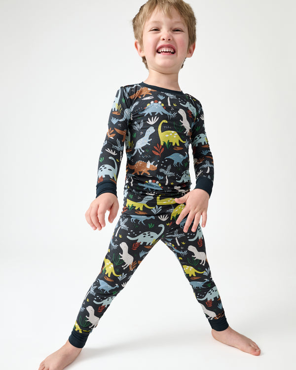 Standing boy wearing the Navy Jurassic Jungle Two-Piece Pajama Set