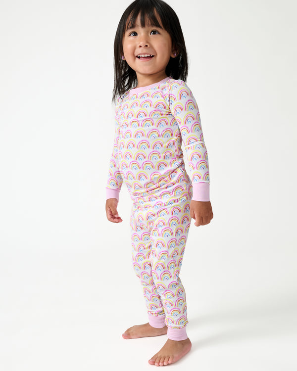 Standing girl wearing the Pastel Rainbows Two-Piece Pajama Set
