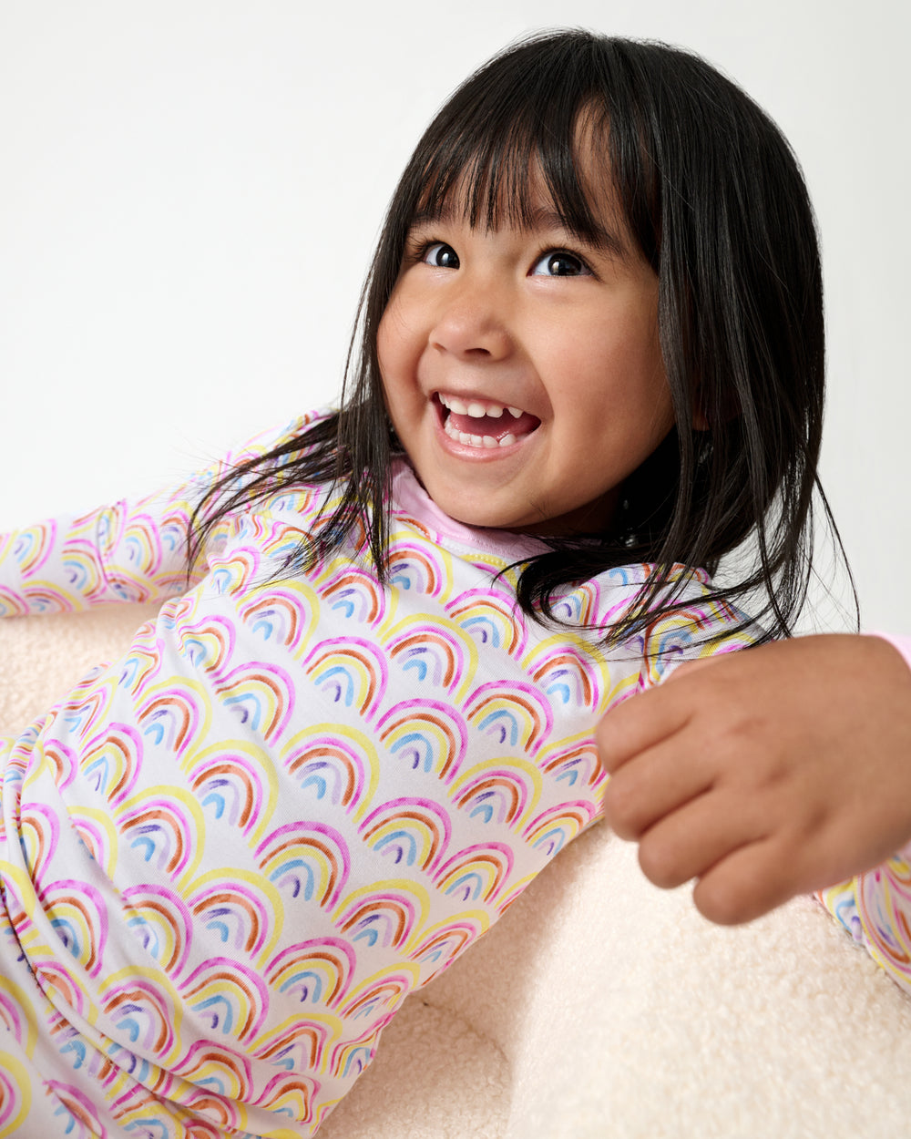 Close up of girl wearing the Pastel Rainbows Two-Piece Pajama Set