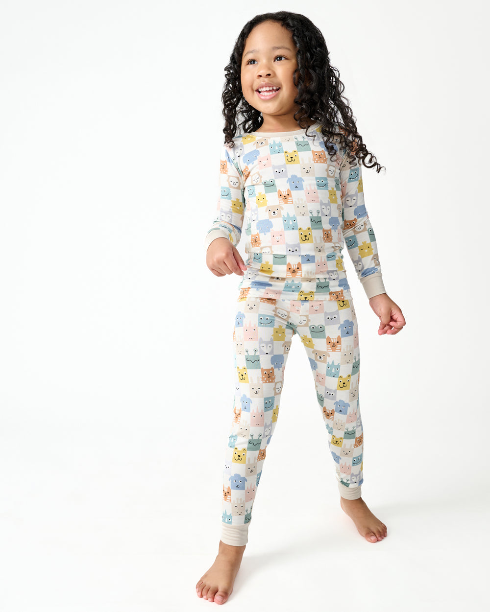 Standing girl wearing the Check Mates Two-Piece Pajama Set