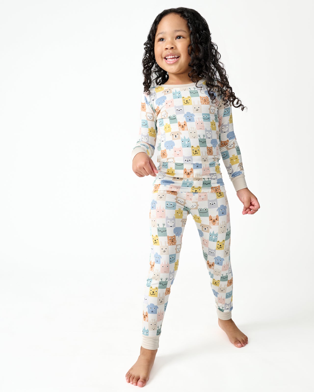 Standing girl wearing the Check Mates Two-Piece Pajama Set