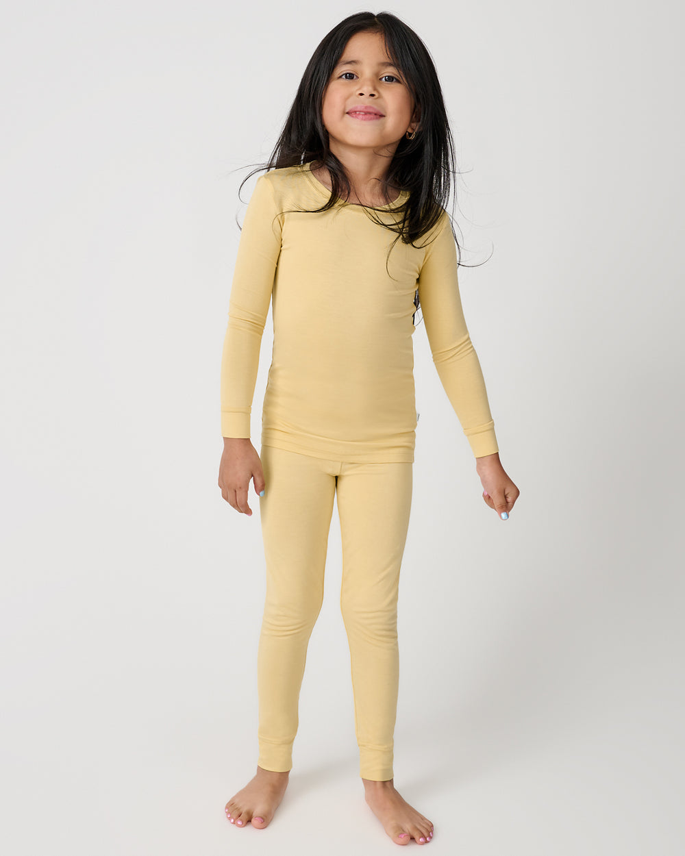 Standing girl wearing the Sunglow Two-Piece Pajama Set