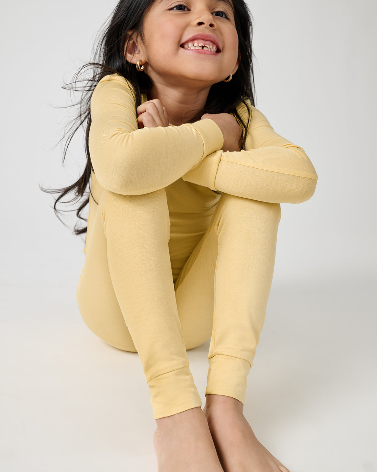 Close up of sitting child wearing the Sunglow Two-Piece Pajama Set