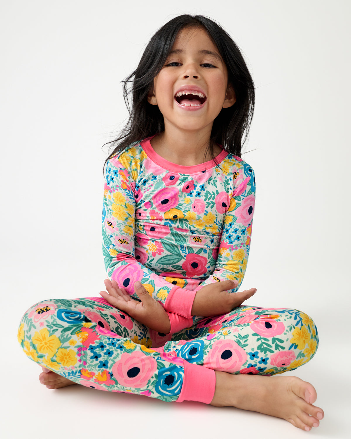 Smiling girl wearing the Secret Garden Floral Two-Piece Pajama Set