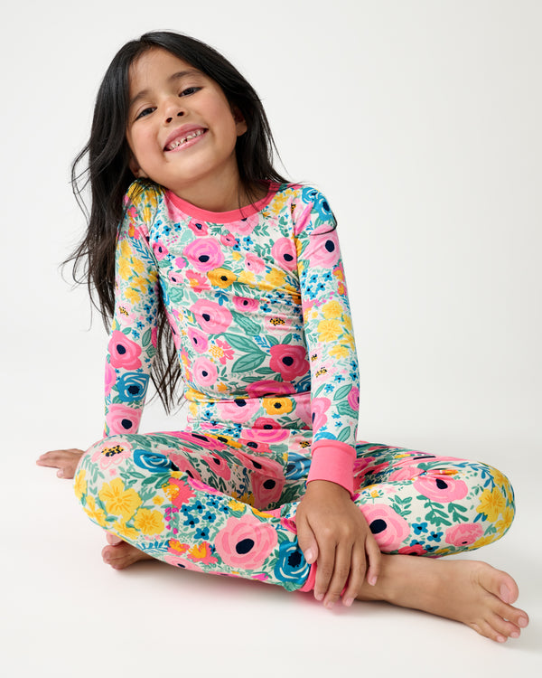 Sitting girl wearing the Secret Garden Two-Piece Pajama Set