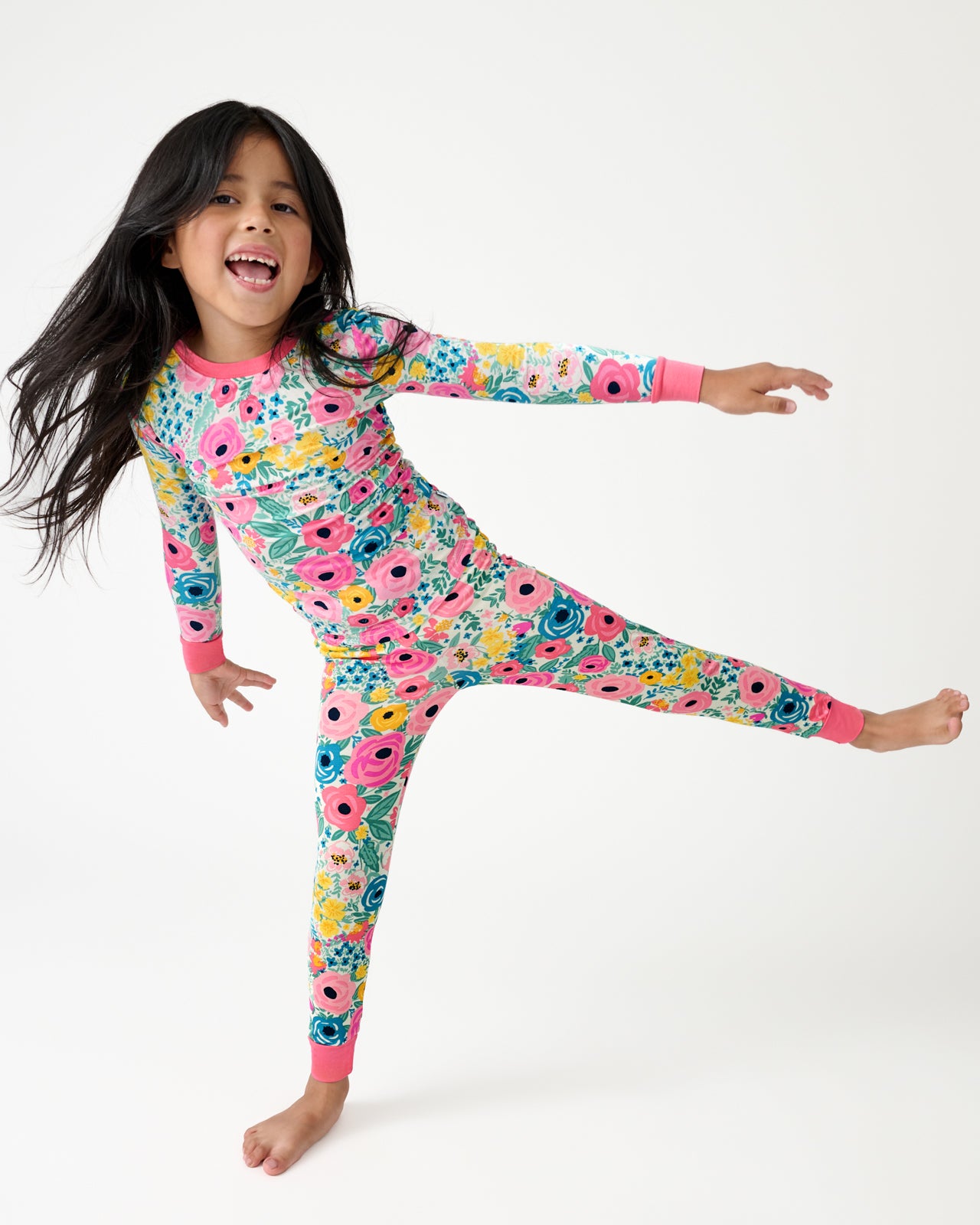 Posing child wearing the Secret Garden Two-Piece Pajama Set